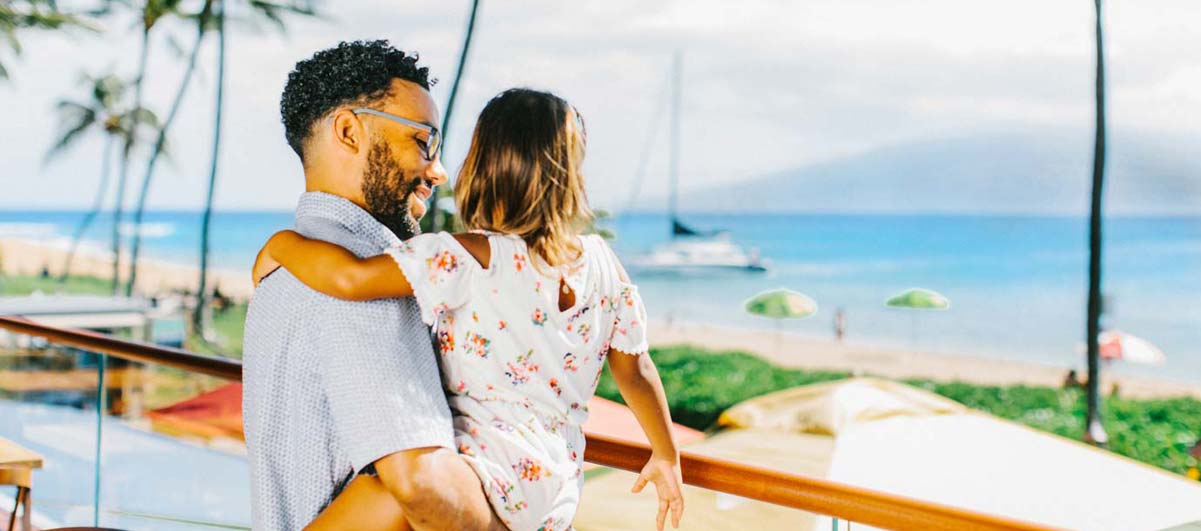 dad and daughter looking at an ocean view