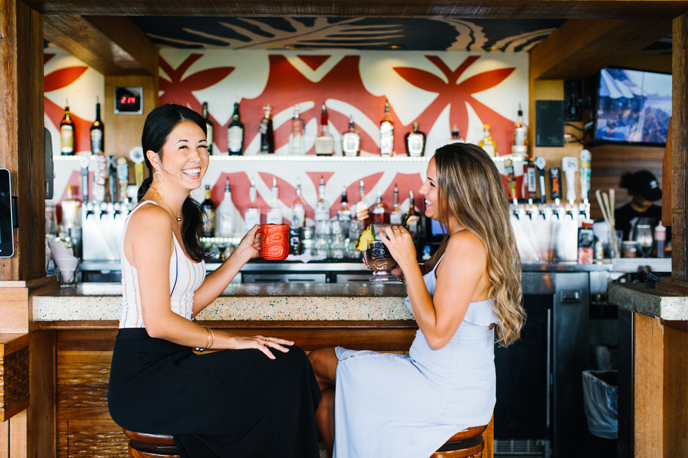 Two women enjoying drinks at the bar